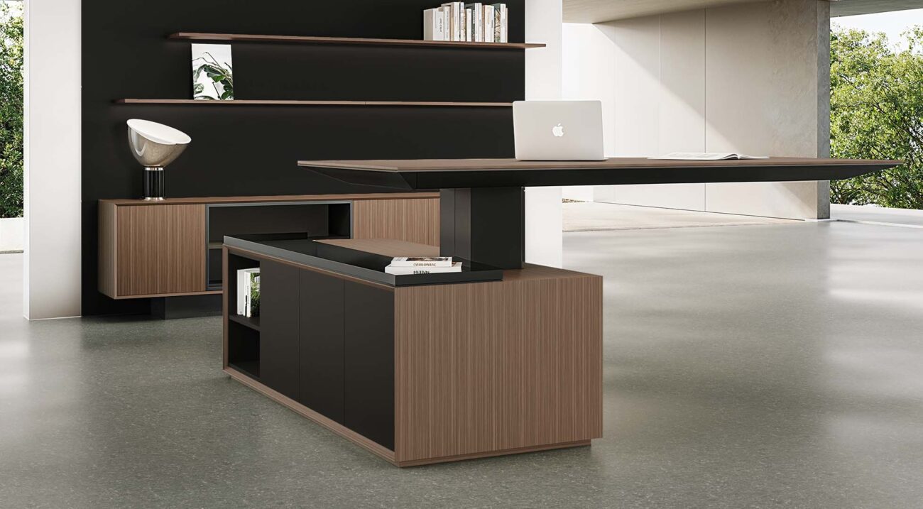 Modern Height Adjustable Desk with a dark wood top, featuring a unique L-shaped configuration with integrated storage and shelving, set in a contemporary office.