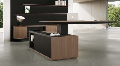 Floating wood and black Height Adjustable Desk with integrated storage, a laptop, and a matching shelving unit.