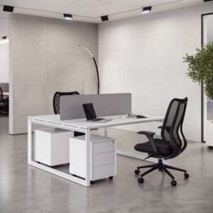Minimalist white shared desk setup with a gray divider, mobile pedestals, and a black mesh Office Chair Dubai.