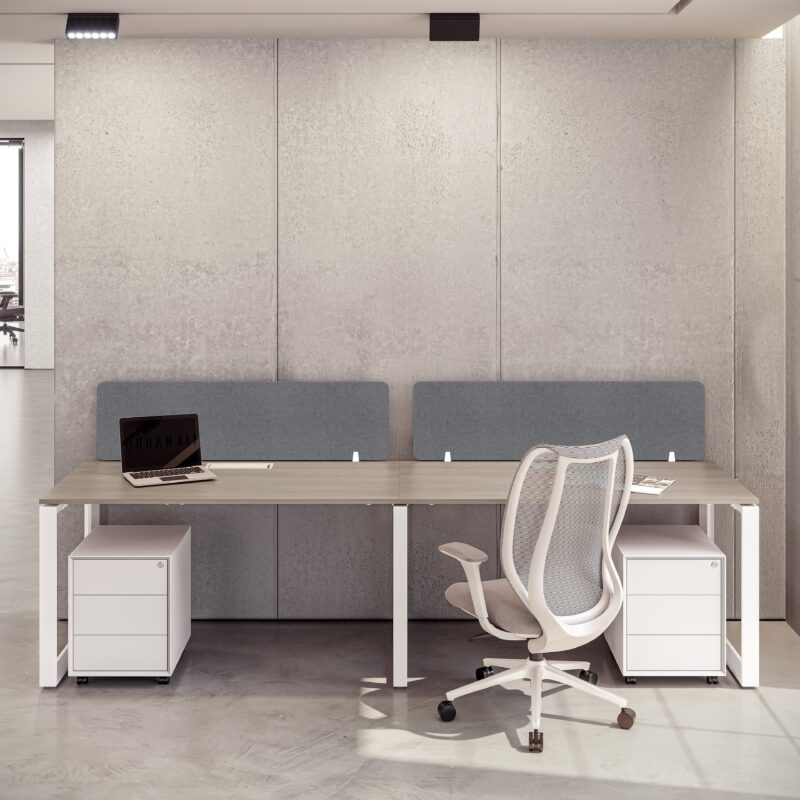 Bright dual workstation with wood-look desks, mobile storage, and a white mesh office chairs Dubai against a concrete wall.
