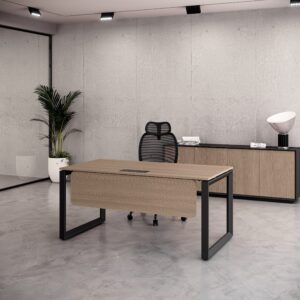 Minimalist private Office Desk with wood top, black frame, black mesh chair, and credenza against a concrete wall.