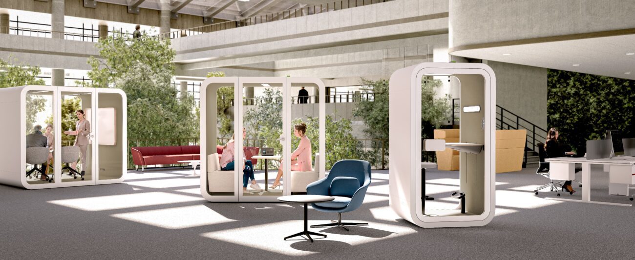 A range of innovative Shop Office Furniture displayed in a large atrium setting, including private meeting pods, casual seating areas, and traditional workstations in the background.