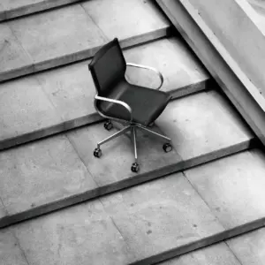 A picture of a black leather office chair in an urban office setting